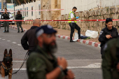 Israeli security forces secure the area where a suspected stabbing incident took place, in Ramle