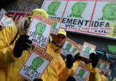 Distributors hold displays of artwork depicting Trump on the day of his inauguration as U.S. president for a second term, by British artist Endless, in London