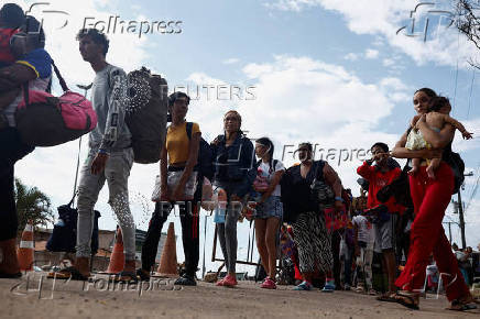 Venezuelans queue to enter a shelter after leaving Venezuela, in Pacaraima