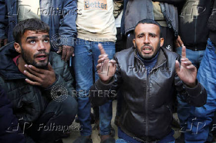 Palestinians mourn loved ones killed in Israeli strikes, in Khan Younis in the southern Gaza Strip