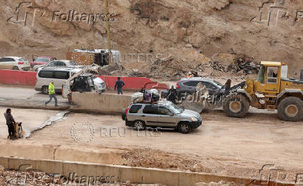 People who had fled the hostilities in Lebanon to Syria drive back with their belongings to Lebanon through the Masnaa border crossing between the two countries