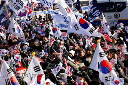 Impeached South Korean President Yoon Suk Yeol's supporters rally near the Corruption Investigation Office for High-ranking Officials, following his arrest, in Gwacheon