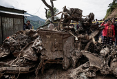 Rescue personnel work to retrieve the bodies of victims from a landslide triggered by heavy rainfall, in Dhading