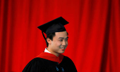 FILE PHOTO: Bo Guagua, son of fallen Chinese politician Bo Xilai, walks offstage after receiving his masters degree at Harvard University in Cambridge