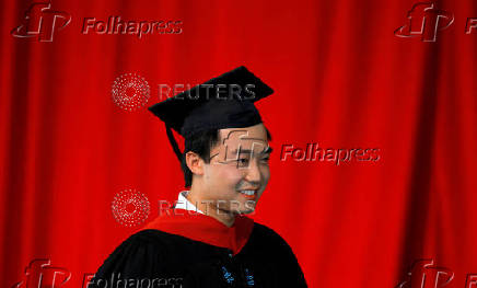 FILE PHOTO: Bo Guagua, son of fallen Chinese politician Bo Xilai, walks offstage after receiving his masters degree at Harvard University in Cambridge