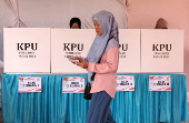 Voters cast their ballows in regional government elections in Indonesia