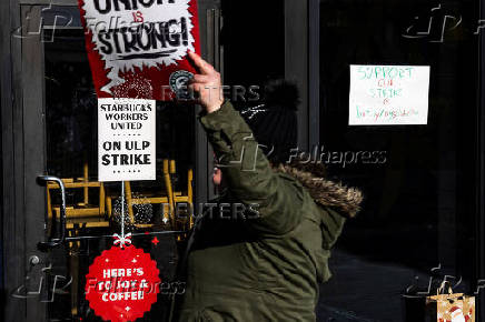 Workers picket in front of a Starbucks in the Brooklyn borough in New York