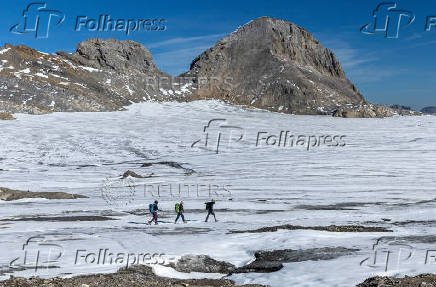FILE PHOTO: Members of the Swiss Glacier Monitoring Network arrive on the Plaine Morte glacier