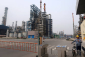 FILE PHOTO: Man is seen at an exit of the refinery plants of Chambroad Petrochemicals in Binzhou, Shandong