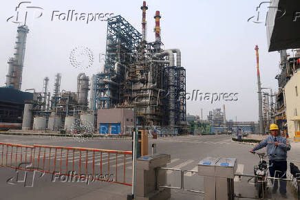 FILE PHOTO: Man is seen at an exit of the refinery plants of Chambroad Petrochemicals in Binzhou, Shandong