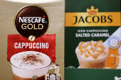 Nescaffe Cappuccino and Jacobs Cappucino are displayed on a shelf in a supermarket