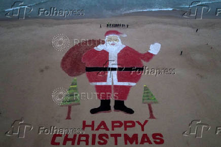 Santa Claus chocolate and sand installation on beach in Puri