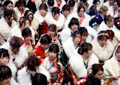 Kimono-clad young women leave the venue after their Coming of Age Day celebration ceremony in Yokohama