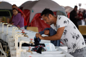 Asylum seekers wait at a temporary shelter for an opportunity to enter the U.S., in Matamoros