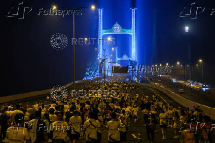 People attend a running event on the newly constructed cable-stayed Rama X Bridge or 