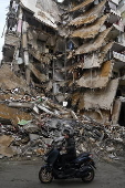 People check damaged buildings after Israeli military strikes on Beirut