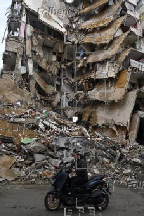 People check damaged buildings after Israeli military strikes on Beirut