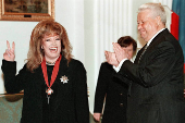 FILE PHOTO: Russian pop singer Alla Pugacheva is applauded by President Boris Yeltsin