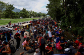 Migrants walk in a caravan in an attempt to reach the U.S. border, in Huixtla