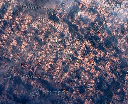 A satellite image shows smoke covering houses after devastating wildfires, in Altadena