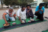 FILE PHOTO: Displaced Sudanese break their fast at a displacement camp during the month of Ramadan, in the city of Port Sudan