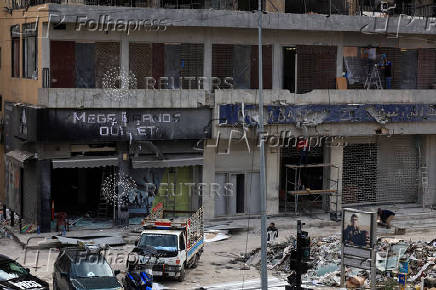 Men renovate their damaged shops, after the ceasefire between Israel and Hezbollah, in Beirut