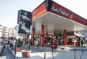 Cars park near a closed gas station in Aleppo