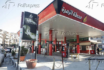 Cars park near a closed gas station in Aleppo