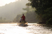 People navigate a river, after attacks by rebels from the leftist National Liberation Army (ELN) in Tibu