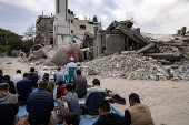 Gaza displaced Palestinians perform Friday prayer near mosque ruins in Rafah