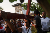 Catholic devotees carry a holy cross at a church parade during the Holy Friday Passion of the Lord Celebrations in Colombo