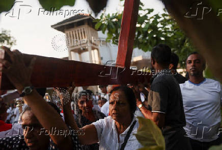 Catholic devotees carry a holy cross at a church parade during the Holy Friday Passion of the Lord Celebrations in Colombo