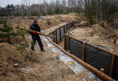 A worker builds a trench as part of a system of new fortification lines near the Russian border in Chernihiv region