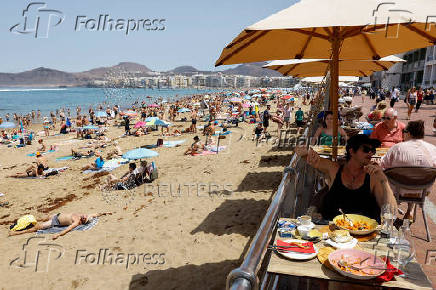 Tourists eat on a terrace next to Las Canteras beach in Las Palmas de Gran Canaria