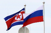 FILE PHOTO: Russian and North Korean flags fly at the Vostochny ?osmodrome in Russia.