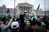 FILE PHOTO: People gather after Syrian rebels announced that they have ousted President Bashar al-Assad, in Vienna