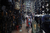 Women walk along the market, in Douma