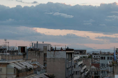 People are seen on a terrace in the neighbourhood of Exarchia, in Athens