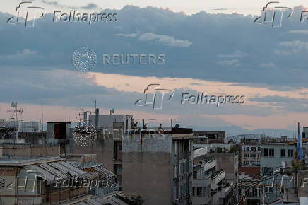 People are seen on a terrace in the neighbourhood of Exarchia, in Athens