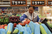 Customer shops at a supermarket in Beijing