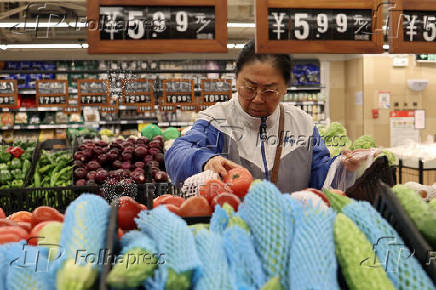 Customer shops at a supermarket in Beijing