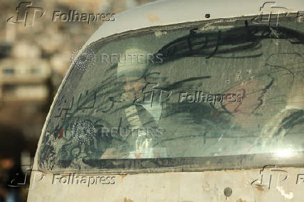 Children look from a vehicle, in Damascus