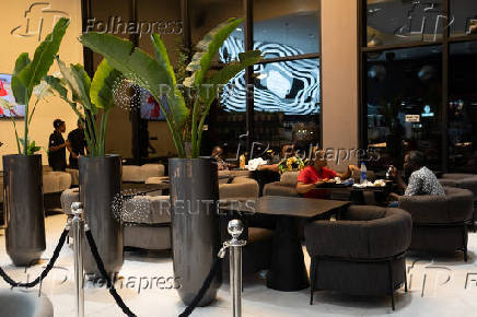 People sit inside a restaurant in Lagos