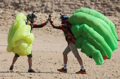 Professional skydivers fly over the historical site of Giza Pyramids, during Egypt International Skydiving Festival 