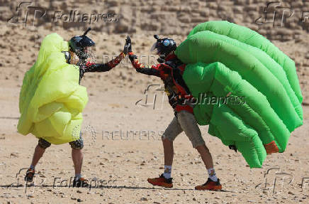 Professional skydivers fly over the historical site of Giza Pyramids, during Egypt International Skydiving Festival 