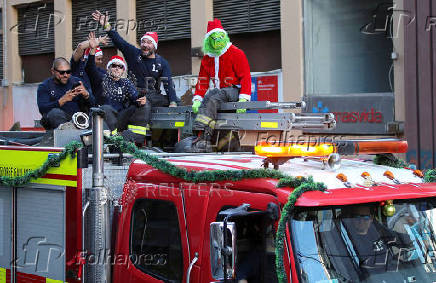 Firefighters greet people during Christmas season celebrations in Valparaiso