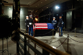 The joint services military honor guard stand around the casket of former President Jimmy Carter in Atlanta