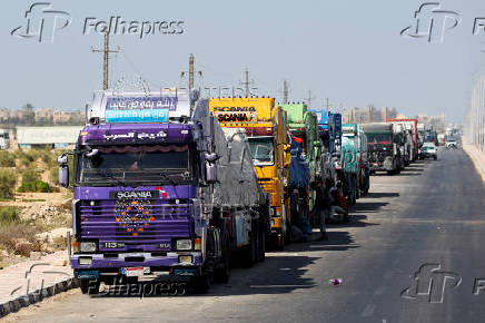 Trucks carrying aid line up near the Rafah border crossing between Egypt and the Gaza Strip, in Rafah