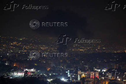 Smoke billows over Beirut's southern suburbs, as seen from Sin El Fil