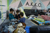 Israelis gather at a bomb shelter following rocket attacks from Lebanon towards Israel, in Acre